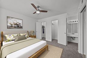 El Paso apartment for rent - A bedroom with a bed, a ceiling fan, and a painting on the wall.