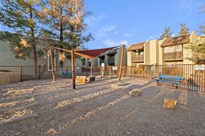 Tucson apartment for rent - A playground with a swing set and a slide.