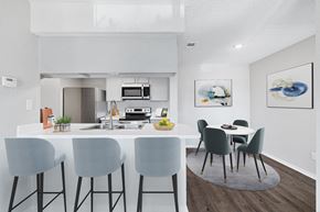 Houston apartment for rent - A modern kitchen with a dining table and chairs.
