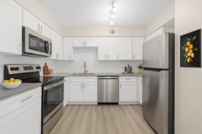 Dallas apartment for rent - A kitchen with white cabinets and stainless steel appliances.