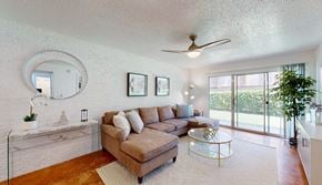 Austin apartment for rent - Living Room with white walls, concrete floors, and sliding glass doors to a patio