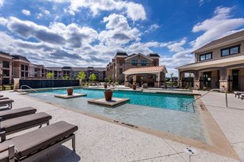 Resort-style swimming pool with cabana and grills