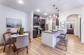 Grand Prairie apartment for rent - A modern kitchen with a dining table and chairs.