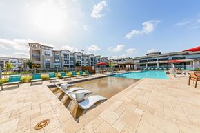 Hutto apartment for rent - A sunny day at the poolside with a clear blue sky.