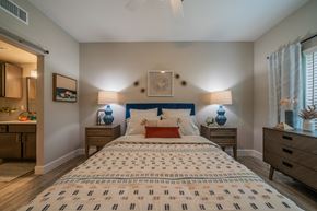 Conroe apartment for rent - a bedroom with a bed and two nightstands