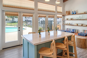 Vista apartment for rent - a kitchen with a table and chairs next to a pool