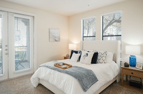 San Antonio apartment for rent - A bedroom with a white bed and a tray of food on it.