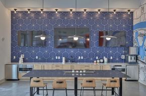 Nashville apartment for rent - A kitchen with a blue patterned wall and a table with four chairs.