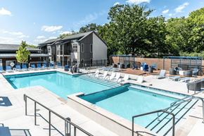 Nashville apartment for rent - A large outdoor swimming pool with a metal railing.