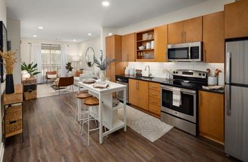 Nashville apartment for rent - A modern kitchen with wooden cabinets and a white island.