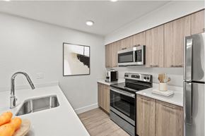 Austin apartment for rent - A kitchen with a white sink and a refrigerator.
