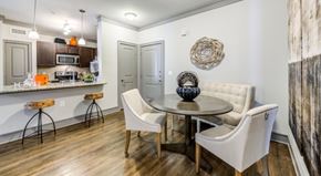 Carrollton apartment for rent - A kitchen with a white table and chairs.