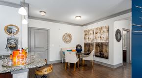 Carrollton apartment for rent - A dining room with a table set for two and a blue accent wall.