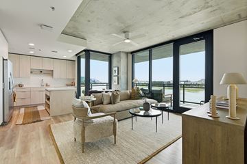 Tempe apartment for rent - A modern living room with a couch, chair, and a table with a lamp on it.