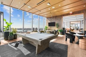 San Diego apartment for rent - A room with a pool table and a view of the city.