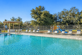 Brandon apartment for rent - A pool with chairs and a pergola in the background.