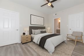 North Richland Hills apartment for rent - A bedroom with a bed, nightstand, and chair.