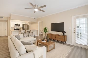 North Richland Hills apartment for rent - A living room with a white couch and a wooden coffee table.