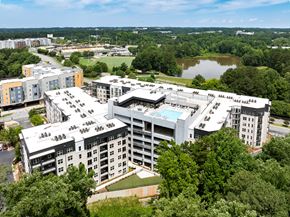 Marietta apartment for rent - A large white building with a pool in the middle of it.