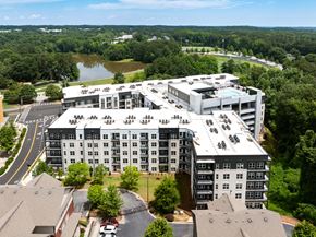 Marietta apartment for rent - A large building with a parking lot in front of it.