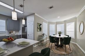 Pearland apartment for rent - A kitchen with a table and chairs in the middle of the room.