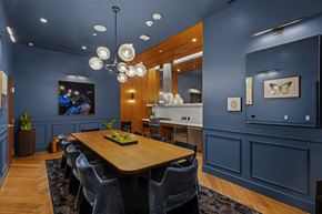 San Diego apartment for rent - A modern dining room with a wooden table and grey chairs.