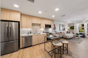San Diego apartment for rent - A modern kitchen with wooden cabinets and stainless steel appliances.