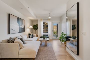 San Diego apartment for rent - A living room with a beige couch and a large painting on the wall.