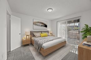 El Paso apartment for rent - A bedroom with a large bed and a painting on the wall.