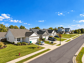 Spring Hill apartment for rent - A residential street with houses on both sides and cars parked in front.