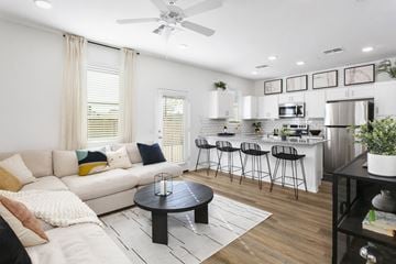 Surprise townhouse for rent - a living room with a couch and a table in front of a kitchen