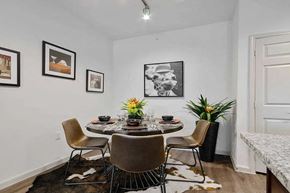 Granbury apartment for rent - A dining room with a table set for four and a cowhide rug.