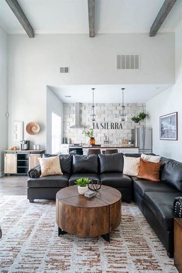 New Braunfels apartment for rent - A living room with a black couch and a coffee table.