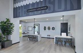 Fort Myers apartment for rent - a rendering of the leasing lounge with a long table with chairs and a bar with stools