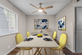 Mesa apartment for rent - A dining room with a white table and yellow chairs.