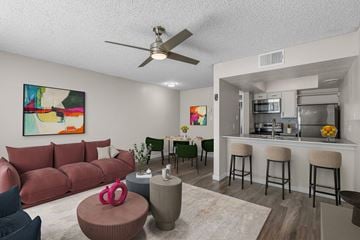 Mesa apartment for rent - A living room with a red couch and a painting on the wall.