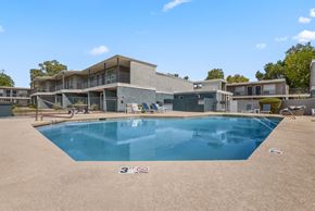 Mesa apartment for rent - a swimming pool in front of a house with a building in the background