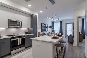 Atlanta apartment for rent - A modern kitchen with a white island and stainless steel appliances.