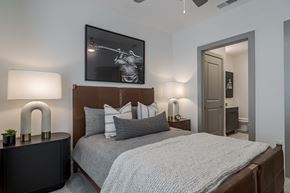 Atlanta apartment for rent - A bedroom with a bed, nightstand, and a painting on the wall.