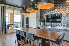 Atlanta apartment for rent - A modern dining room with a wooden table and chairs.