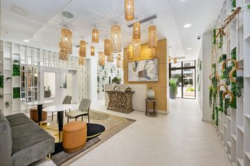 Fort Lauderdale apartment for rent - A modern living room with a grey sofa and a white coffee table.