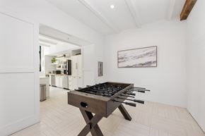 Fort Lauderdale apartment for rent - A modern kitchen with a wooden table and a painting on the wall.