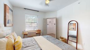 Dallas apartment for rent - a bedroom with a bed and a mirror