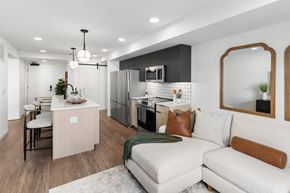 Jackson apartment for rent - A modern kitchen with a white couch and a wooden island.