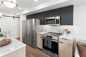 Jackson apartment for rent - A modern kitchen with a refrigerator, oven, and microwave.