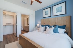 Houston apartment for rent - A bedroom with a large bed and two pictures on the wall.