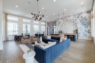 Houston apartment for rent - A living room with a blue sofa and wooden floors.