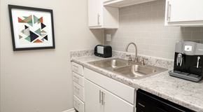 San Antonio apartment for rent - kitchen sink with white cabinets