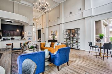 Fort Worth apartment for rent - A living room with a blue chair and a yellow sofa.