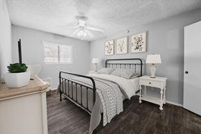 Austin apartment for rent - a bedroom with a bed and a ceiling fan